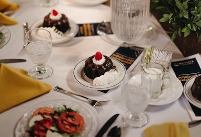 Dessert and coffee cups scattered on a table after the Scholarship Celebration dinner