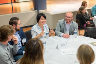 Professionals engage in conversation at Table 4 during a Bethel Biz roundtable event.