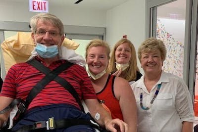 John during recovery with Joan and their two daughters