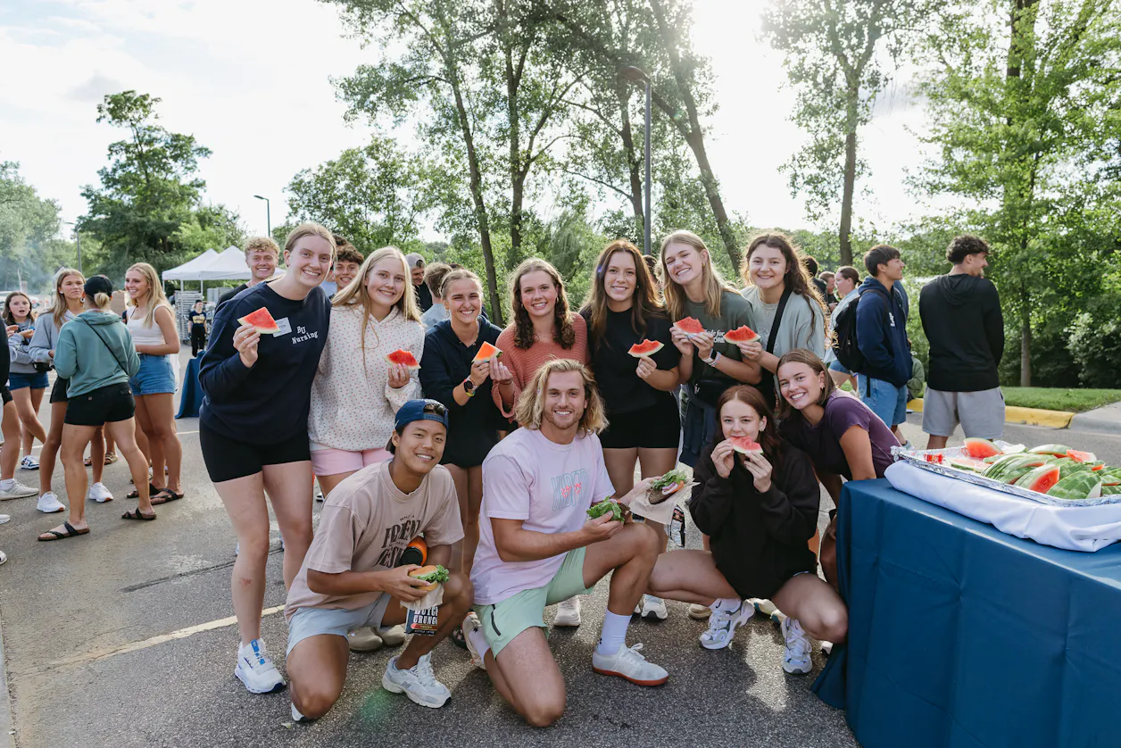 Students eat watermelon at the Welcome Week picnic