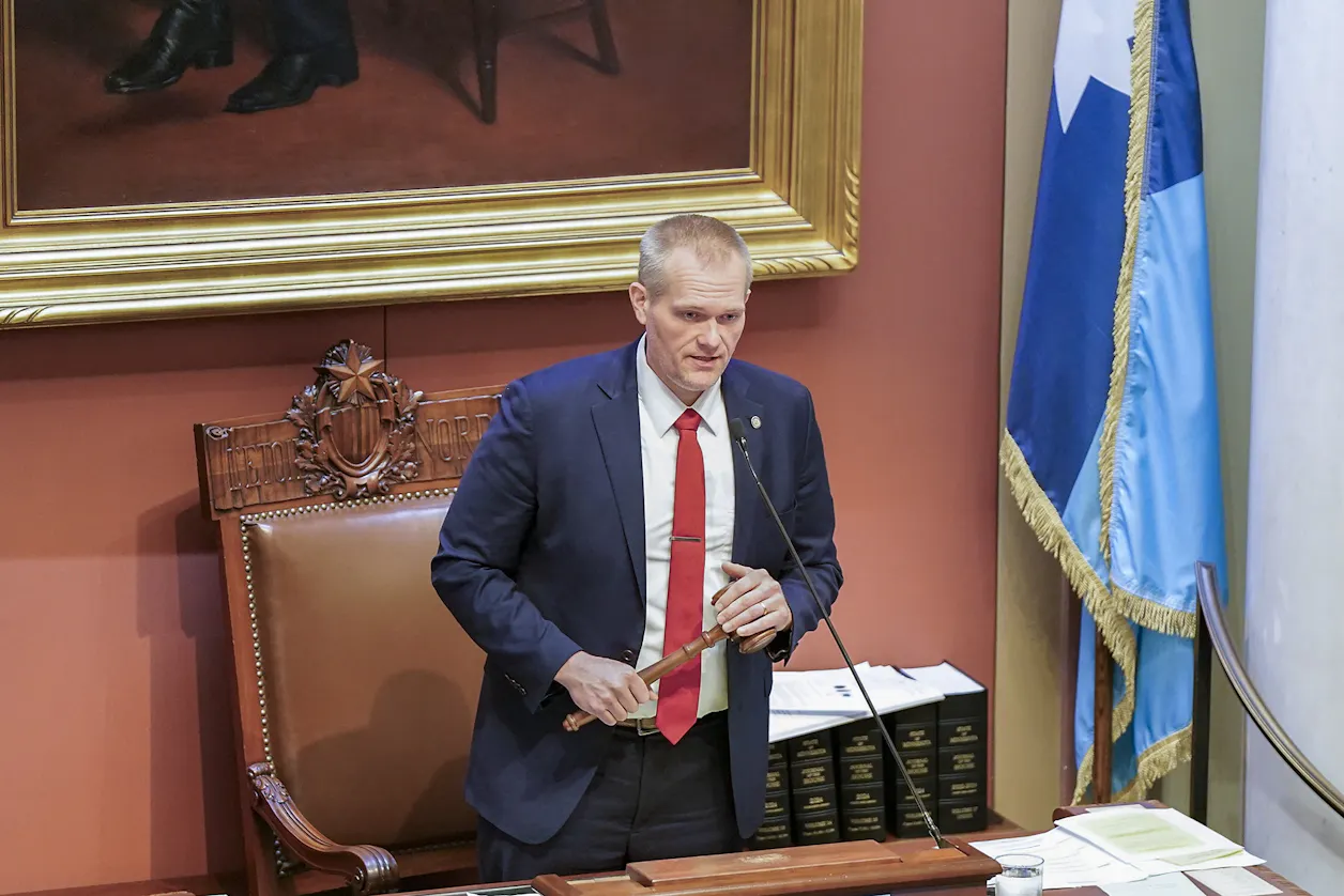 Man holding a gavel speaks from the Minnesota House speaker’s desk.