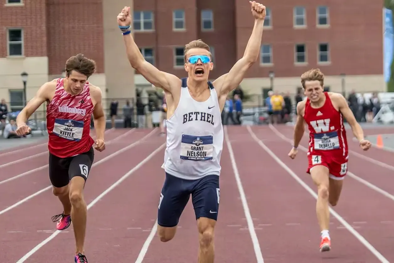 Bethel runner Grant Nelson celebrates as he crosses the finish line first.