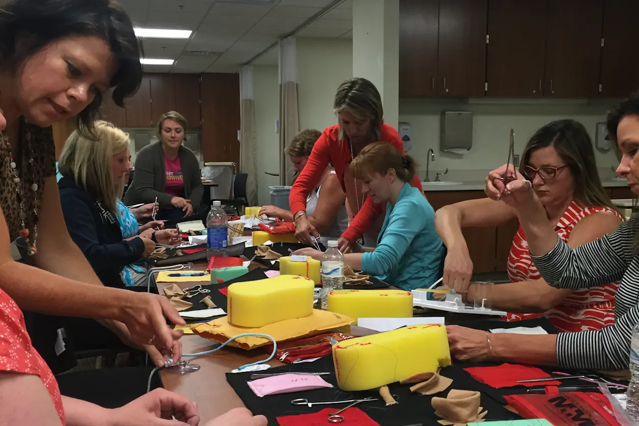 Students practice suture techniques during August 2015 intensives in Bethel's nurse-midwifery program. Left to right: Professor of Nursing Jane Wrede, Leah Schroeder GS'16, former nurse-midwifery program director Katrina Wu, Nicole Rothgarn GS'16, Clinical Professor of Nursing Julie Ann Vingers, Nicole Hunter-Severson GS'17, Ann Rice GS'16, and Karen Sonnenburg GS'16