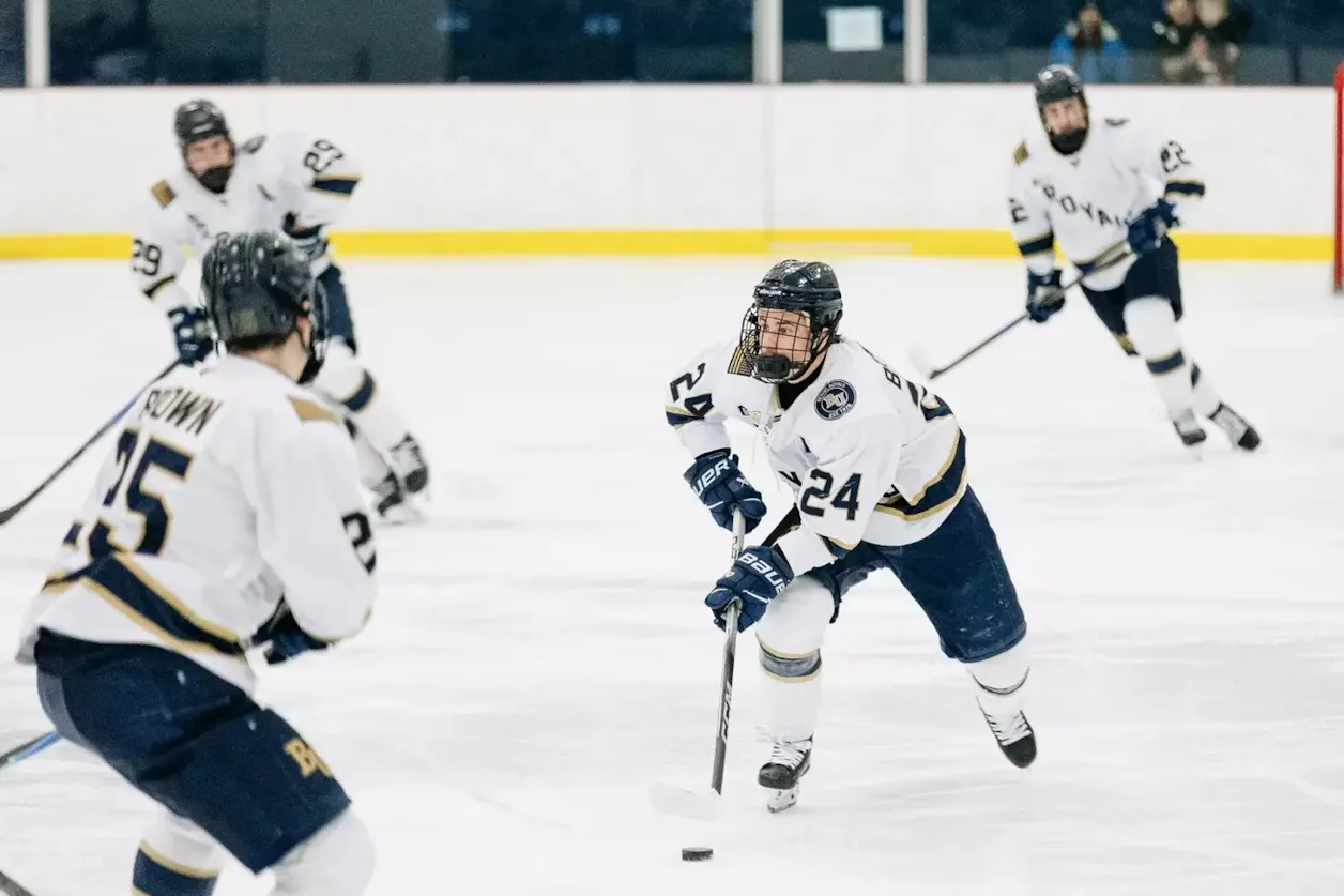 Bethel players skate and pass puck during game action