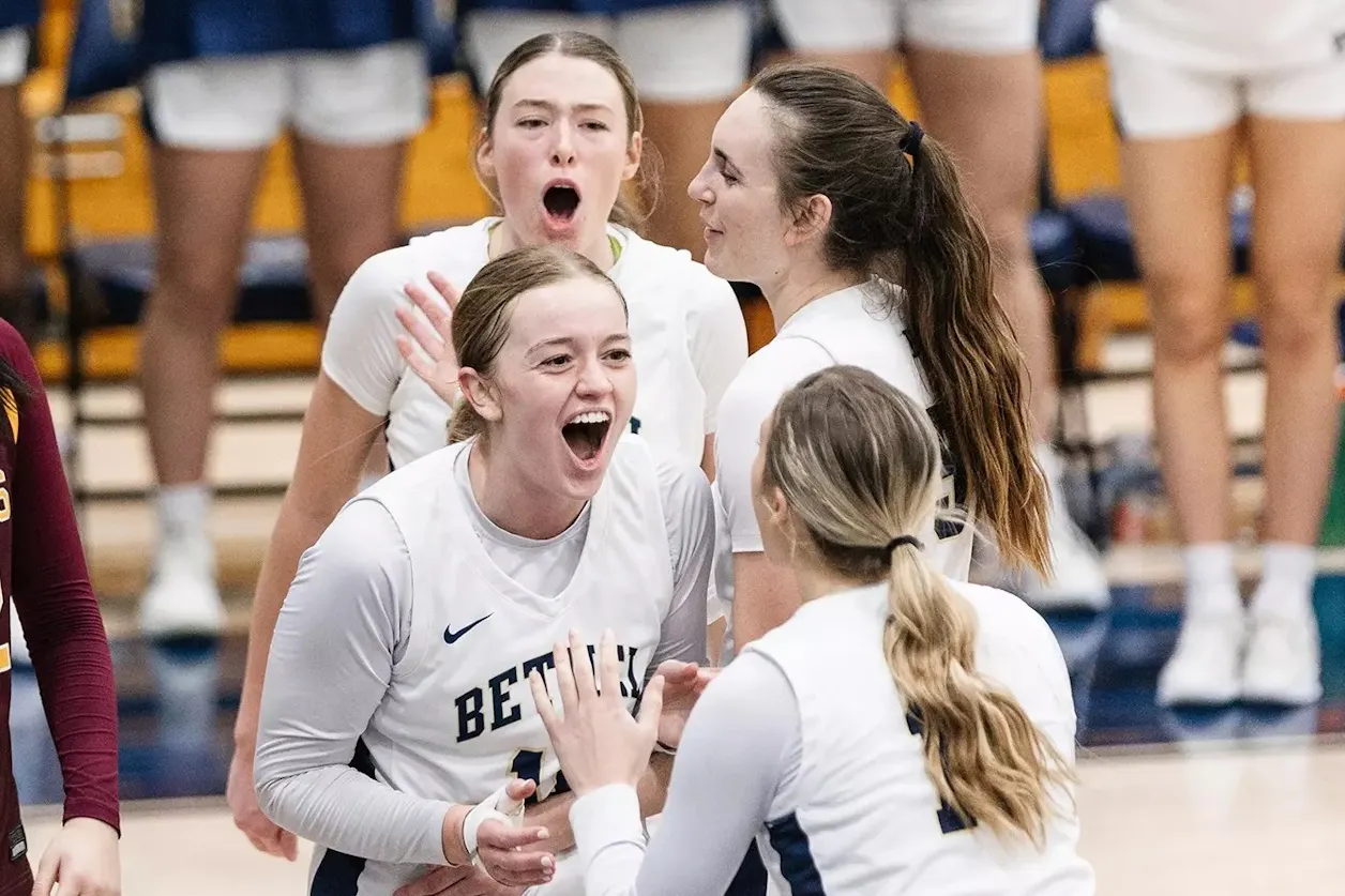 Bethel teammates celebrate point with energetic huddle