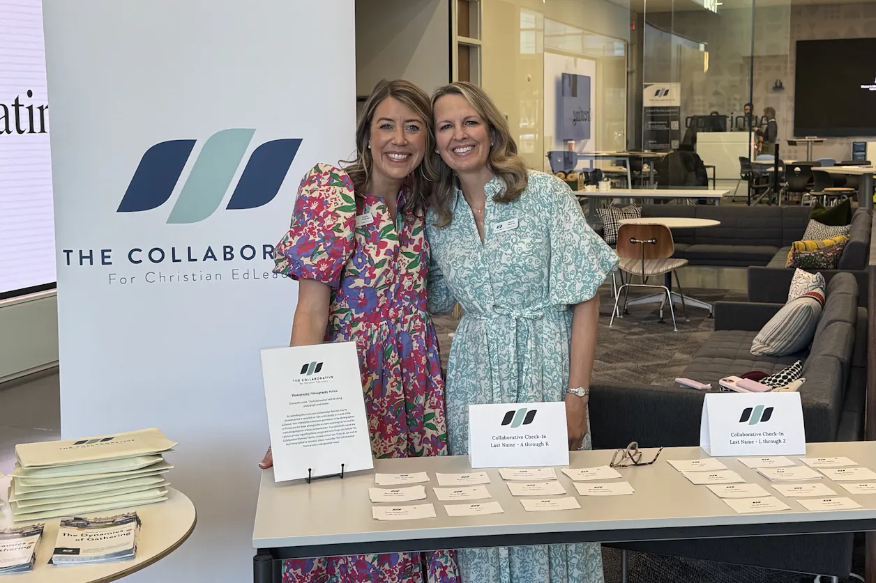 Anderson and Kopischke stand at The Collaborative booth wearing floral dresses. 