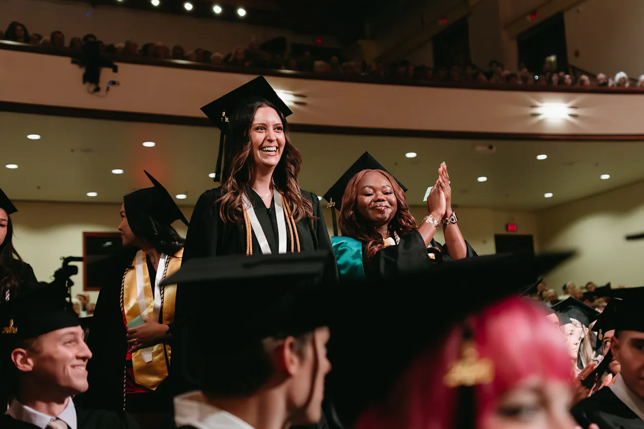 First-generation graduate delivers commencement remarks from the podium.