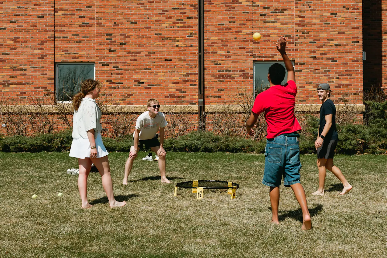 Four students playing spike ball