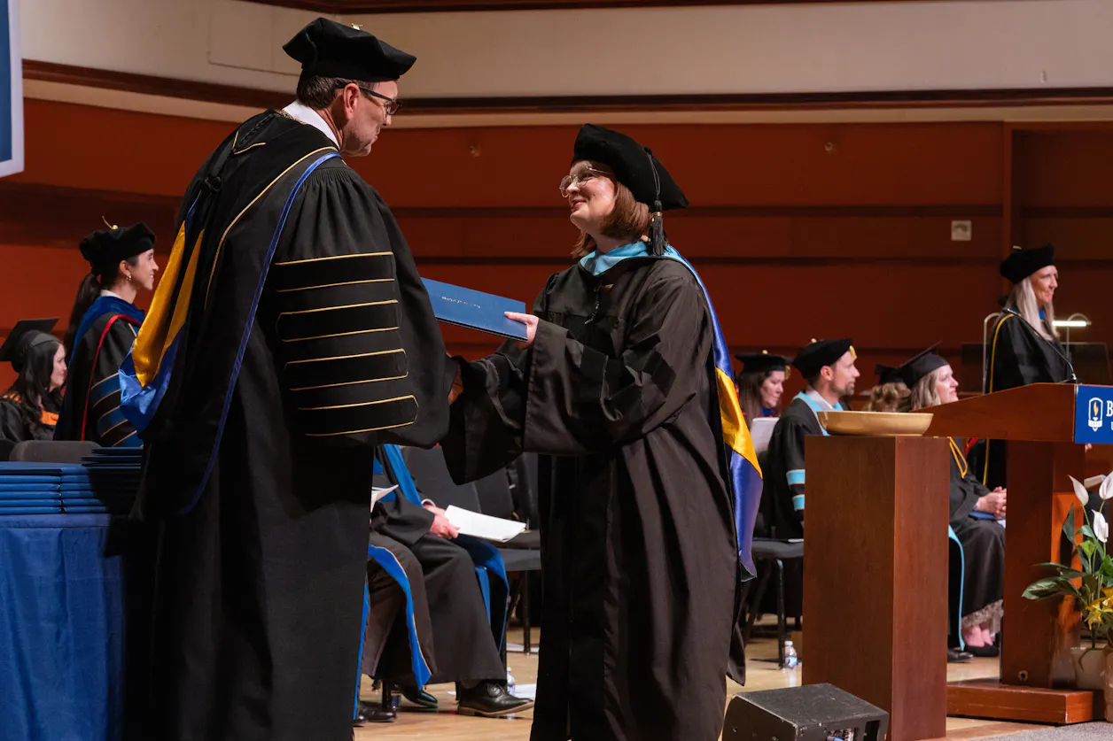 Krista Aadland ’03, S’12, GS’25 receives her doctorate diploma in Benson Great Hall