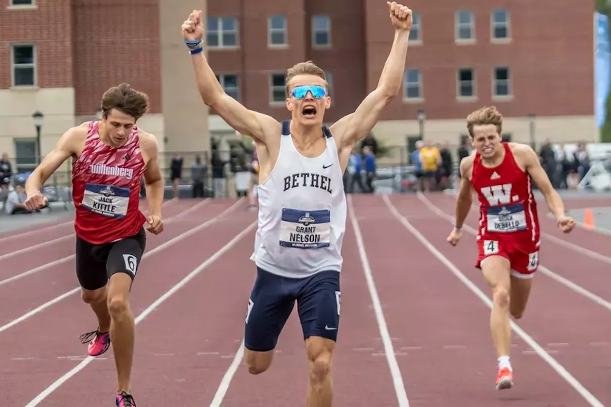 Bethel runner Grant Nelson celebrates as he crosses the finish line first.