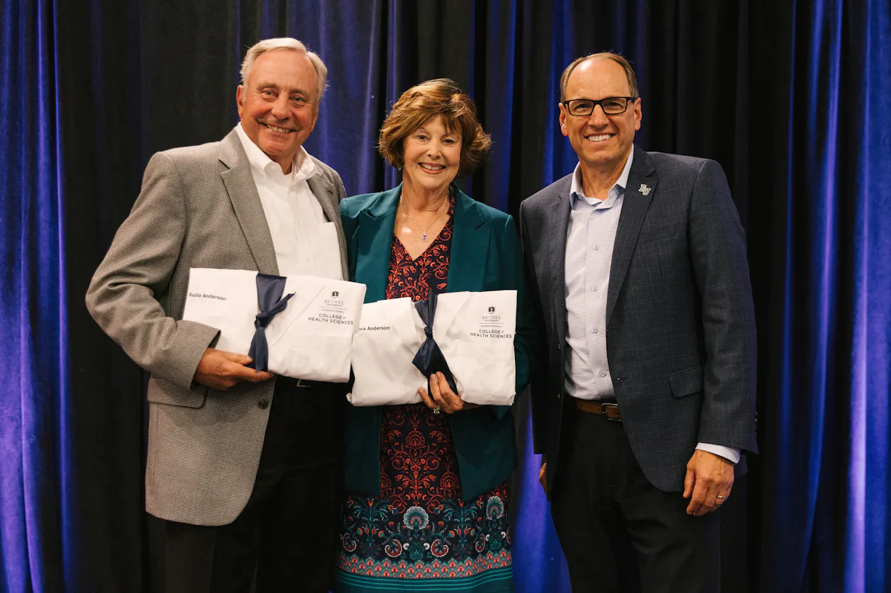 Bethel President Ross Allen thanked and prayed over donors Barb GS'01 and Rollie Anderson, who were presented with the first official Anderson Family College of Health Sciences medical coats. 