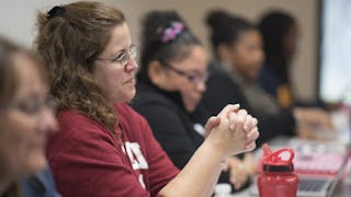 Seminary students listening in class.