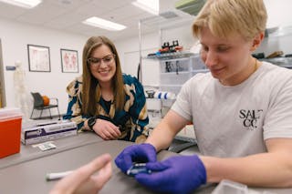 Professor supervising a student during a lab exercise. 