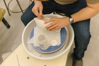 Focused student working on a printmaking project with precision.