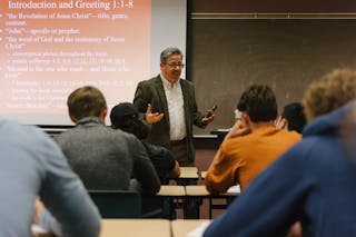 Professor passionately teaching a lesson on the book of Revelation. 