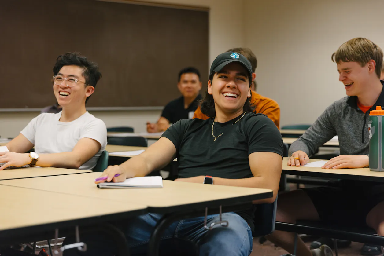 Students engaging in a lively discussion during a classroom session. 