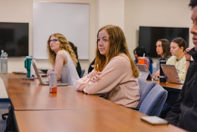 Students attentively listening to a lecture in a classroom.