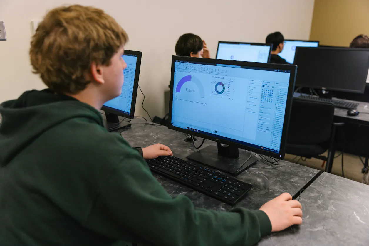 Student working on a computer in a lab, analyzing data.