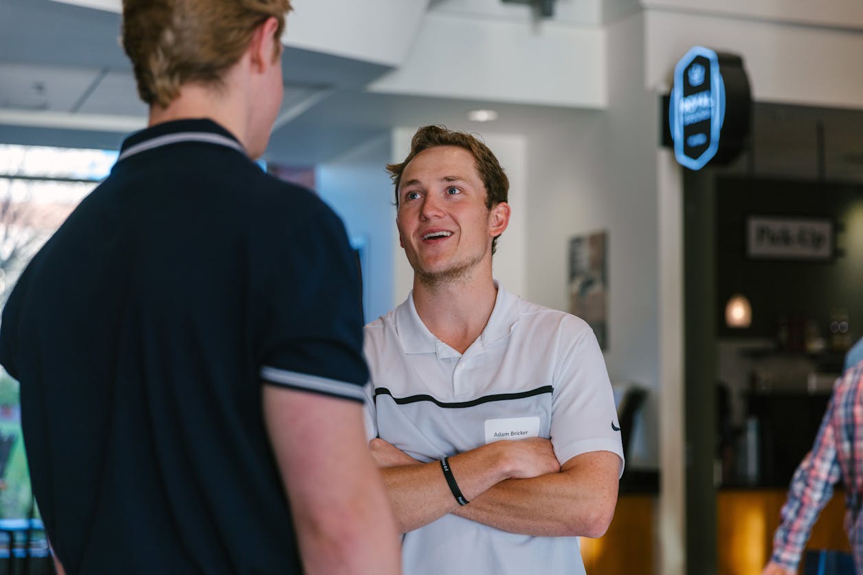 Student talking with another student at an event.