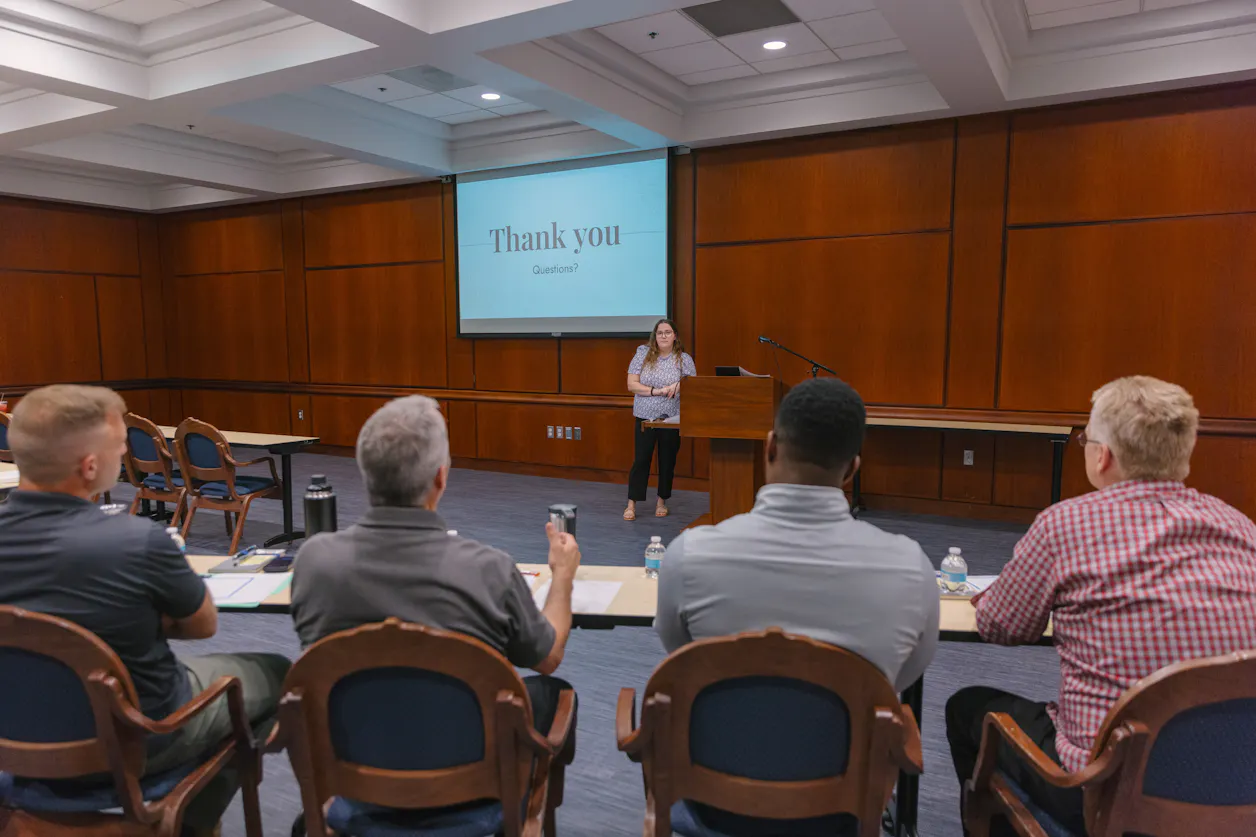 Student presenting in a classroom, engaging the audience with a presentation.