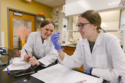 Two students working on a chemistry experiment together.