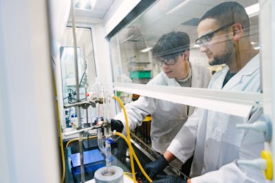 Students using lab equipment for a chemistry experiment.