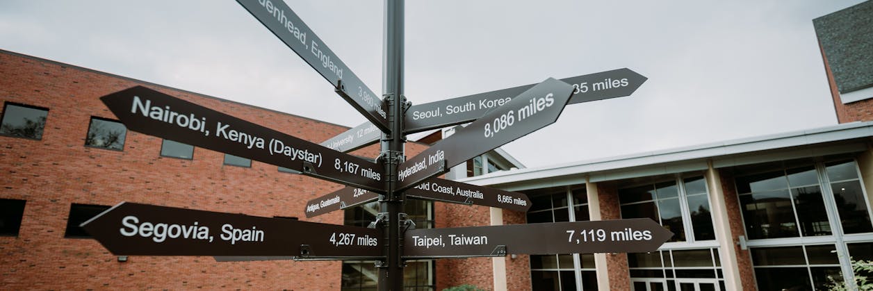 Photo of a directional sign including destinations around the world