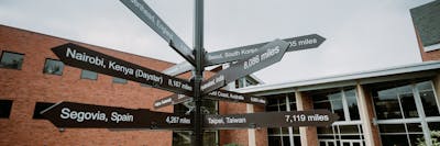 Photo of a directional sign including destinations around the world