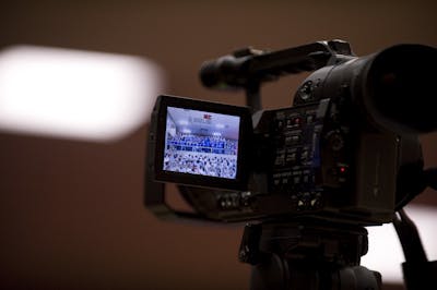 Close-up of a camera's display screen showing an ongoing event being recorded.