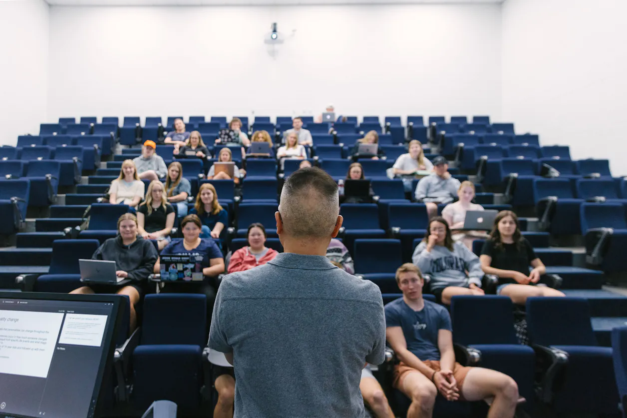A professor addresses a classroom of international relations students.