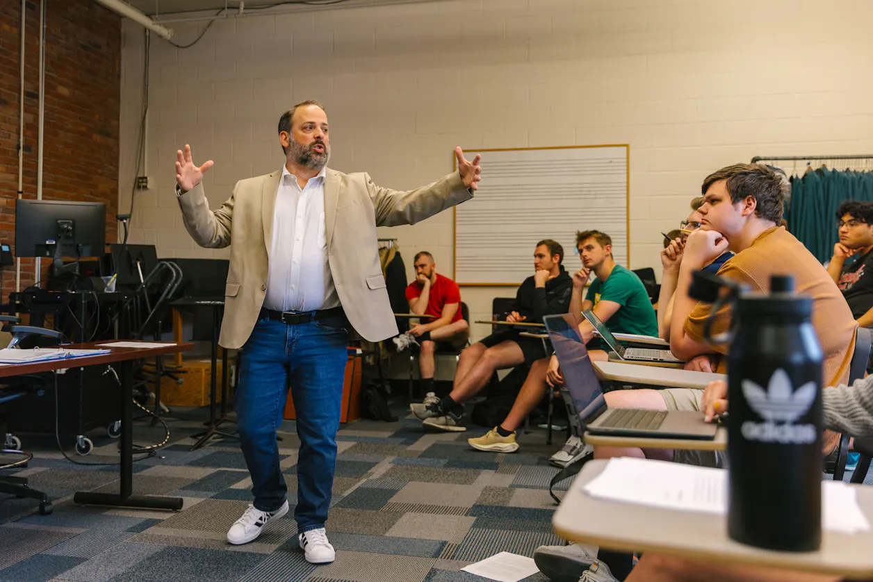 A Bethel University professor passionately lectures to a classroom full of engaged students.