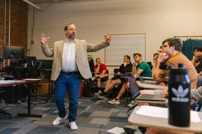 A Bethel University professor passionately lectures to a classroom full of engaged students.