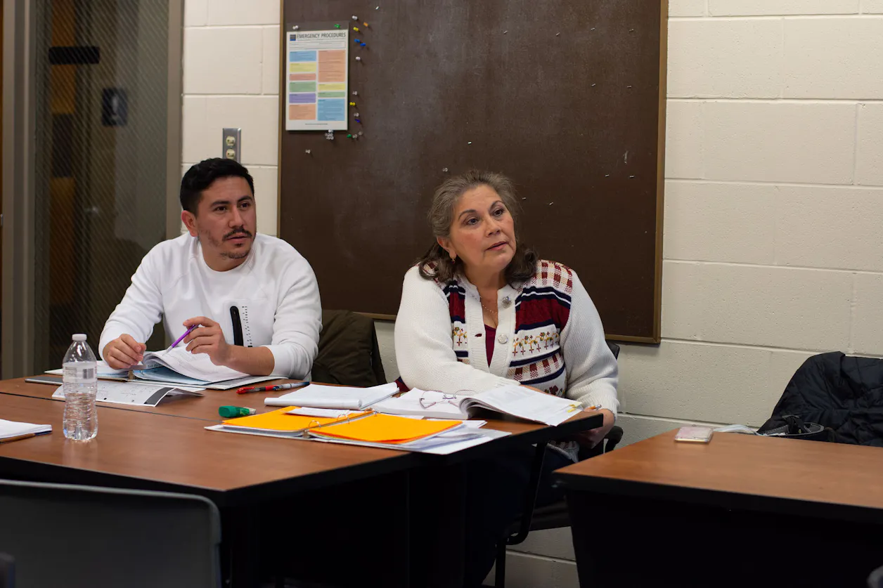 Two students engaged in discussion during a classroom activity. 