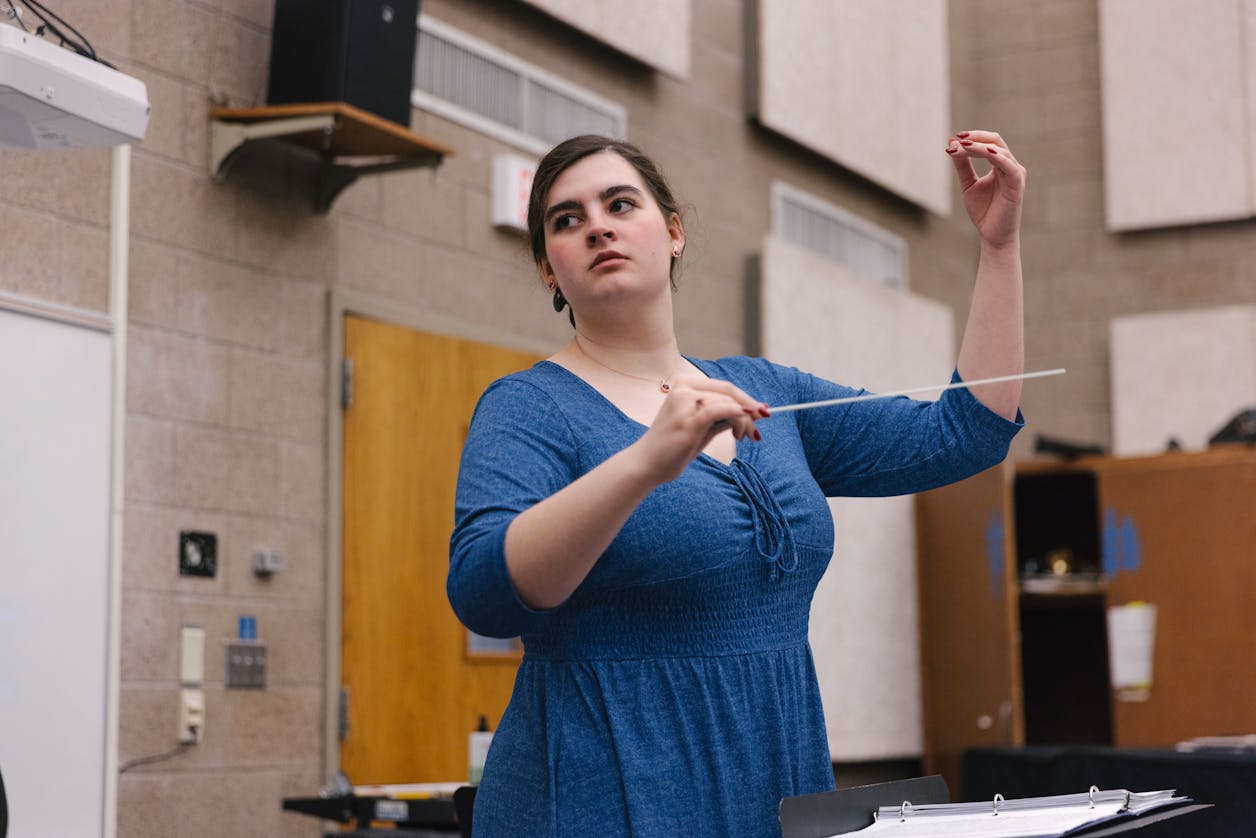 Student conductor directing a rehearsal at Bethel University, showcasing leadership and musical skill.