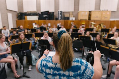 Band rehearsal at Bethel University, viewed from the back of the conductor, highlighting the focused musicians.