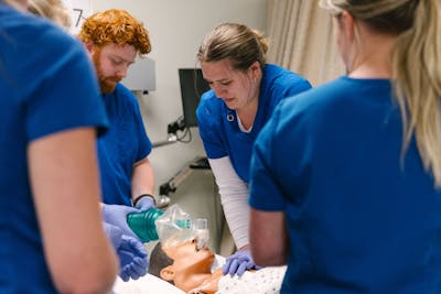 Nursing students practice CPR on a mannequin at Bethel University.