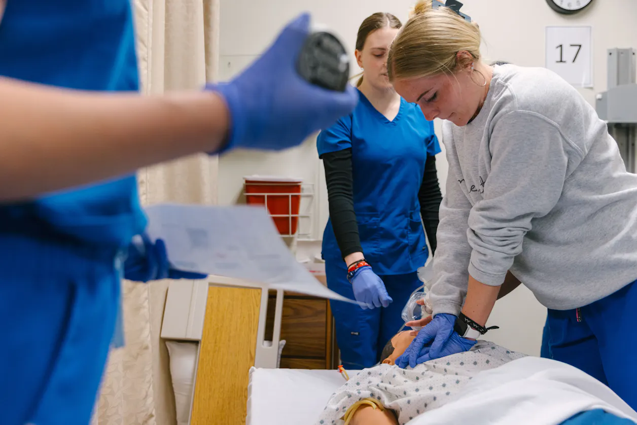 Bethel University nursing students perform chest compressions during a training session.