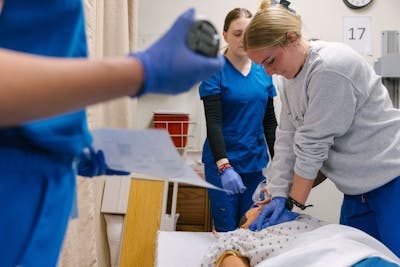 Bethel University nursing students perform chest compressions during a training session.