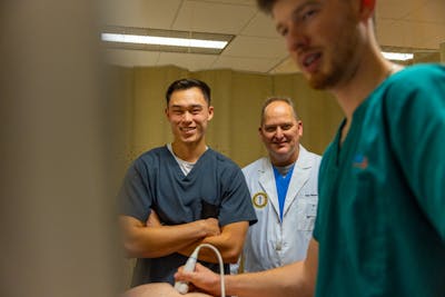 Bethel students performing practice mammogram in lab