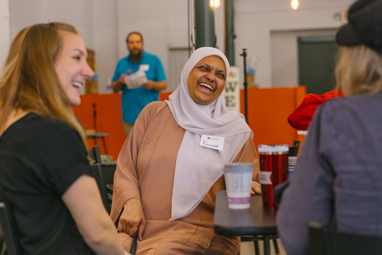 A group of students enjoying a light-hearted conversation during a casual meet-up.