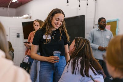 Two students having a friendly conversation during a break in the classroom.