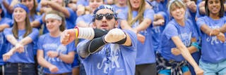 Student leading his residence hall at the homecoming cheer competition