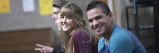 Students sitting and smiling at the camera